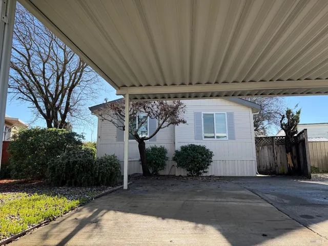 a view of a backyard with plants and outdoor seating