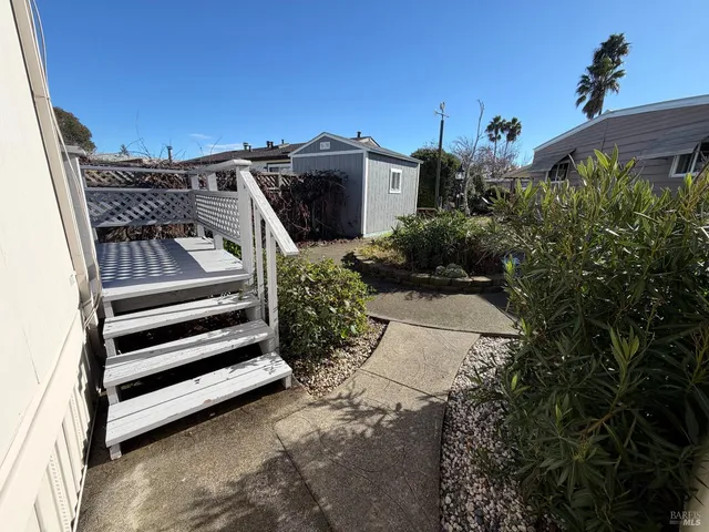 a view of a backyard with plants and a utility room