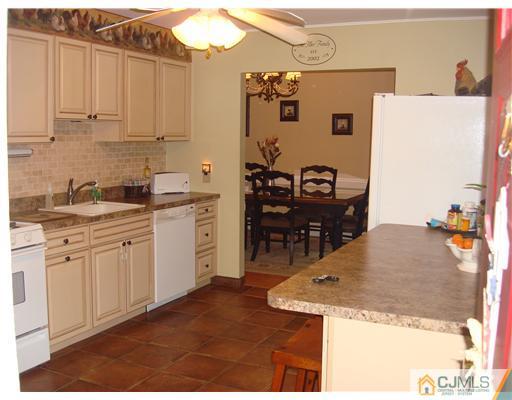 22 Baxter Road Edison, NJ 08817 - Photo 12 of 17 a kitchen with stainless steel appliances granite countertop a sink a stove and white cabinets