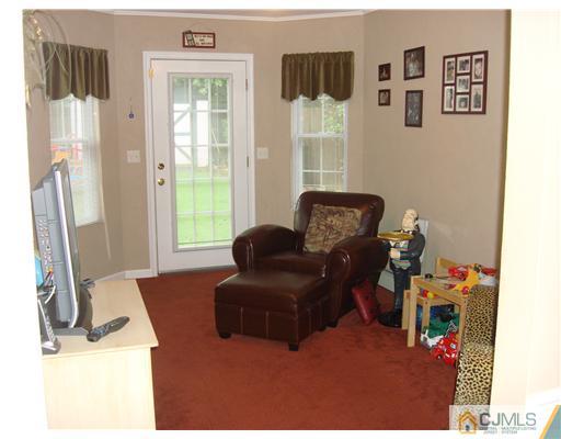 22 Baxter Road Edison, NJ 08817 - Photo 14 of 17 a living room with furniture window and a flat screen tv