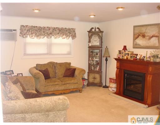 22 Baxter Road Edison, NJ 08817 - Photo 7 of 17 a living room with furniture a window and a fireplace