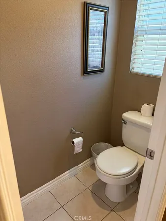 a white toilet sitting next to a window