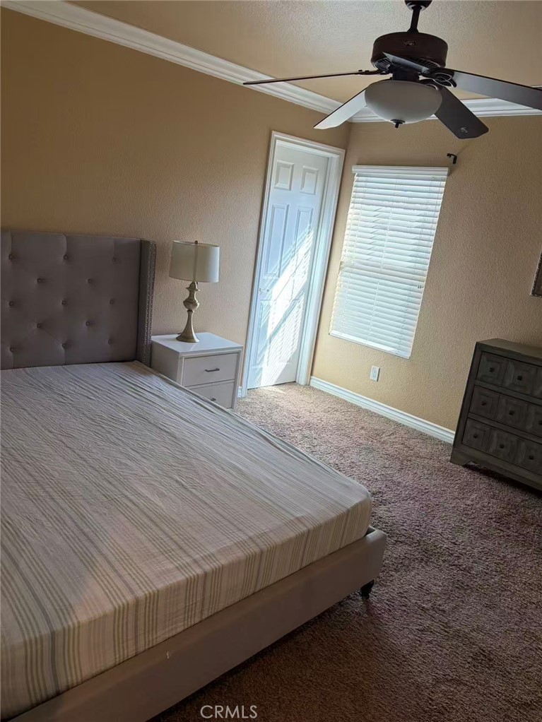 11090 Mountain View Drive, Unit 71 Rancho Cucamonga, CA 91730 - Photo 15 of 24 a bedroom with a bed and wooden floor