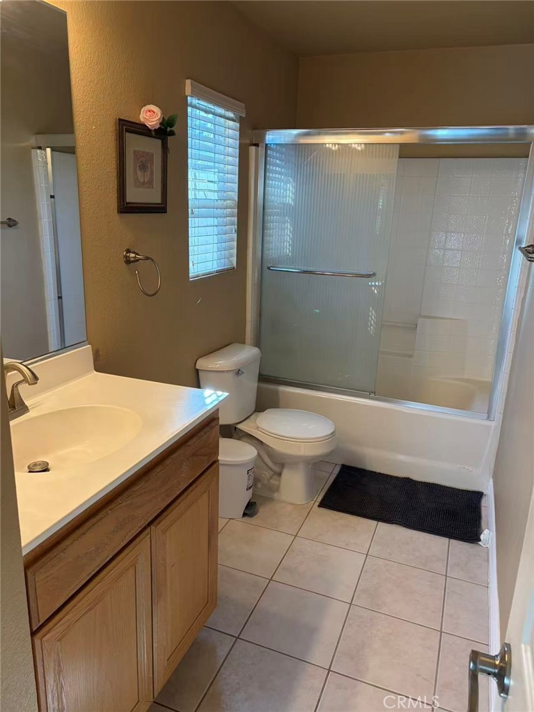 11090 Mountain View Drive, Unit 71 Rancho Cucamonga, CA 91730 - Photo 17 of 24 a bathroom with a sink a toilet and shower