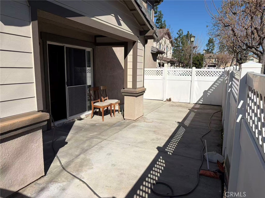 11090 Mountain View Drive, Unit 71 Rancho Cucamonga, CA 91730 - Photo 23 of 24 a view of a patio with a table and chairs