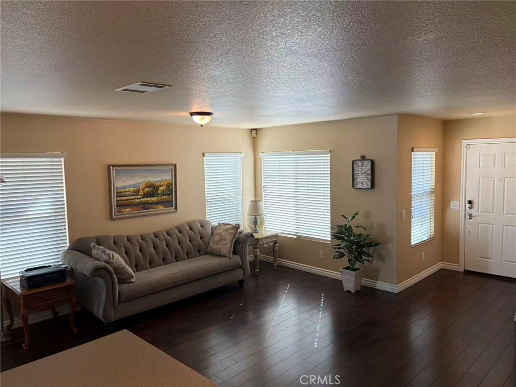 11090 Mountain View Drive, Unit 71 Rancho Cucamonga, CA 91730 - Photo 3 of 24 a living room with furniture window and wooden floor