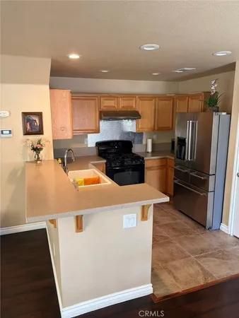 a kitchen with a refrigerator sink and stove