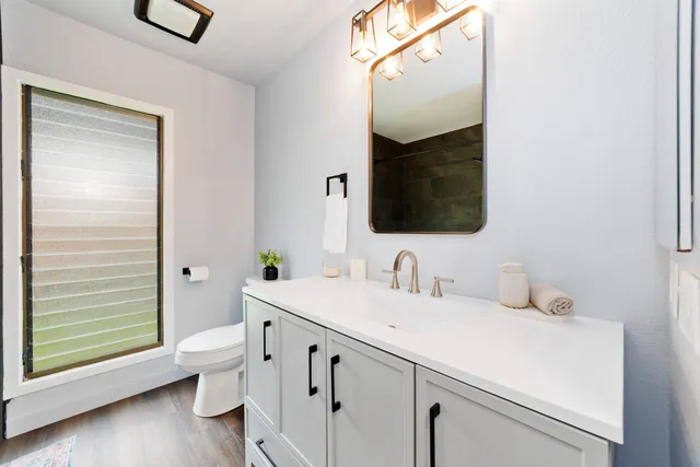 a bathroom with a sink toilet and shower