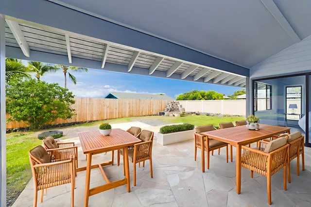 a table and chairs with the view of white walls