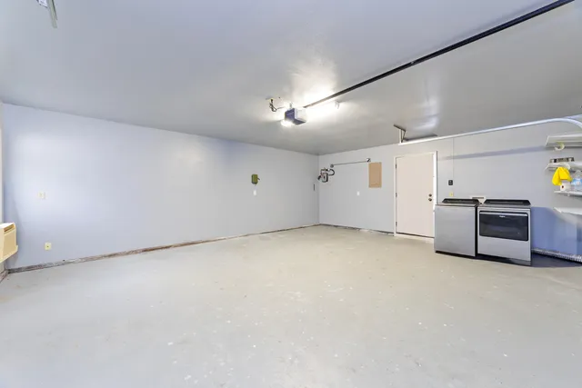a view of an empty room with a kitchen