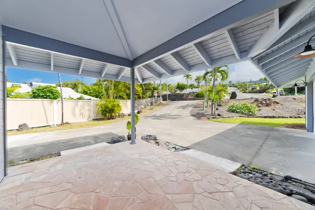 a view of a patio with table and chairs under an umbrella