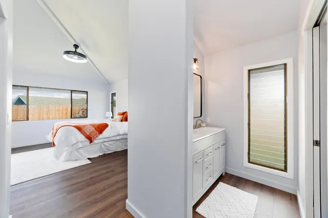 a bedroom with furniture and a wooden floor