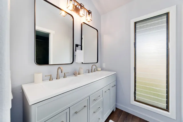 a bathroom with a double vanity sink and mirror