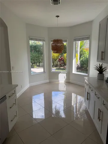 a kitchen with a sink appliances and cabinets