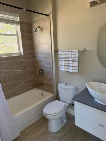 a view of walk in closet with wooden floor