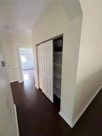 a room with pool table and windows