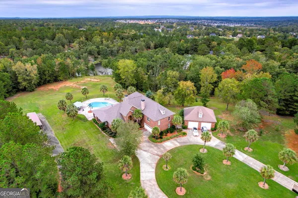 an aerial view of a house with a yard