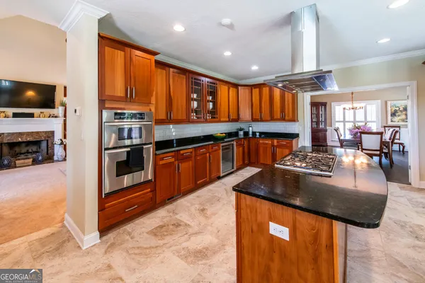 a kitchen with stainless steel appliances granite countertop a stove a sink and a microwave