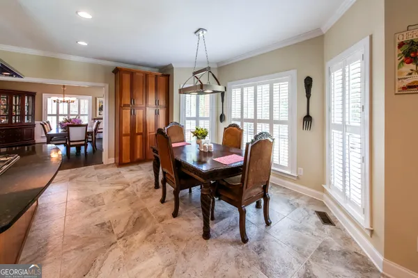 a dining room with furniture and window