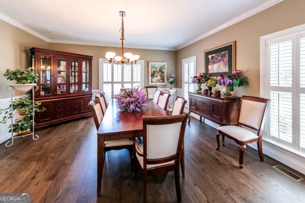 a view of a dining room with furniture window and wooden floor