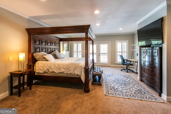 a bedroom with bed and glass door