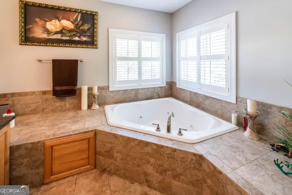 a bath tub sitting in a bathroom next to a window
