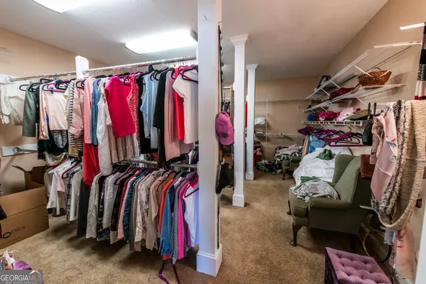 a view of walk in closet with clothes