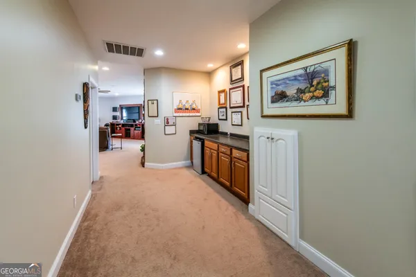 a view of a kitchen with furniture and refrigerator