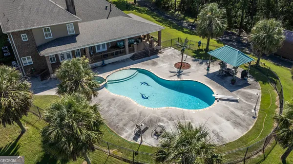 an aerial view of a house with a swimming pool