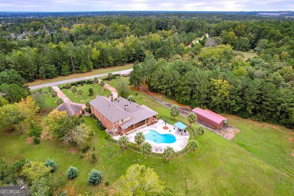 an aerial view of a house with a yard