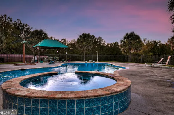 a view of a swimming pool with an outdoor space and seating area
