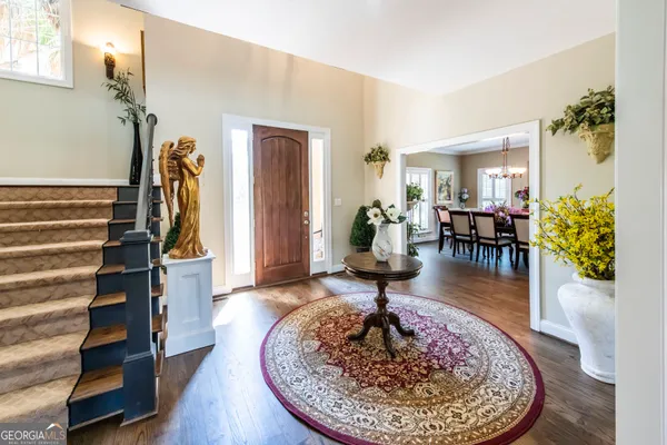 a living room with furniture and a dining table