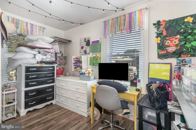 a view of a workspace with furniture and a window