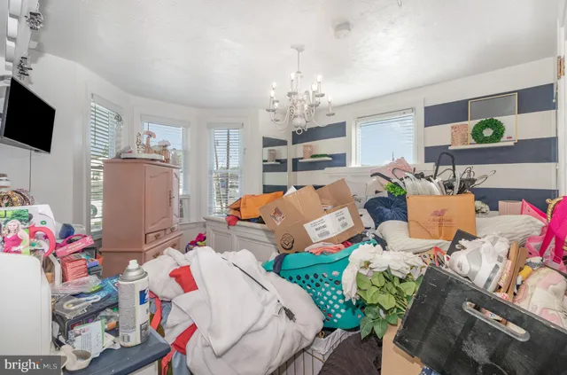 a bedroom with furniture and a flat screen tv