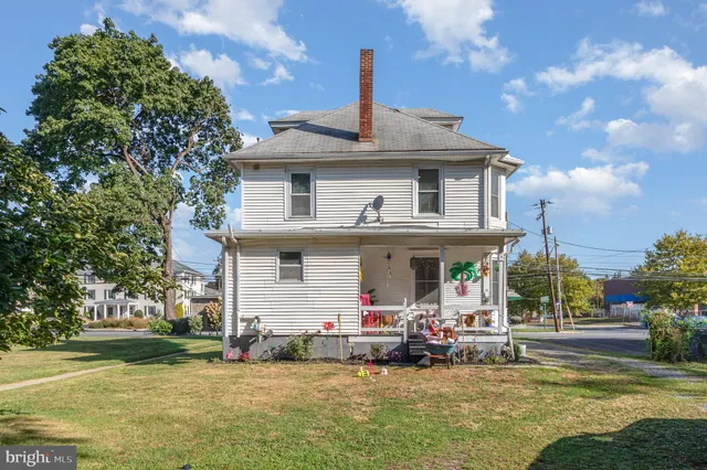 a view of a house with a swimming pool and a yard