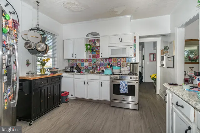 a kitchen with stove and cabinets