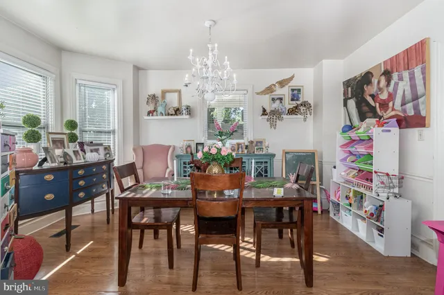 a view of a dining room with furniture and chandelier