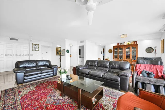 a living room with furniture a rug and a flat screen tv