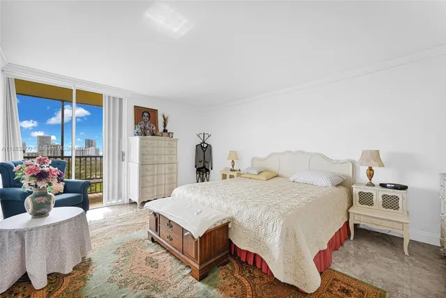 a bedroom with a bed and a view of kitchen