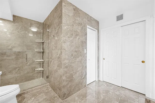 a view of walk in closet with clothes