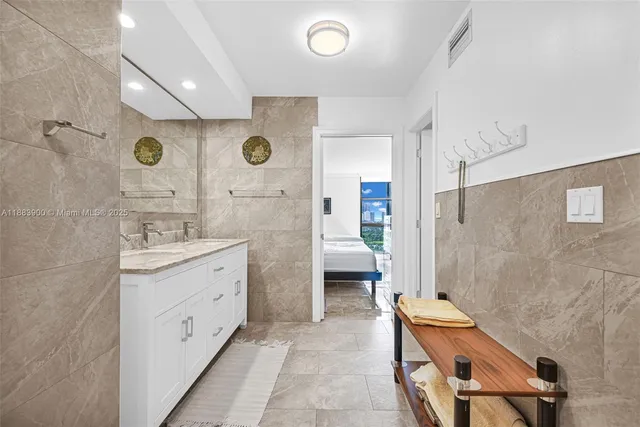 a bathroom with a granite countertop shower sink and mirror