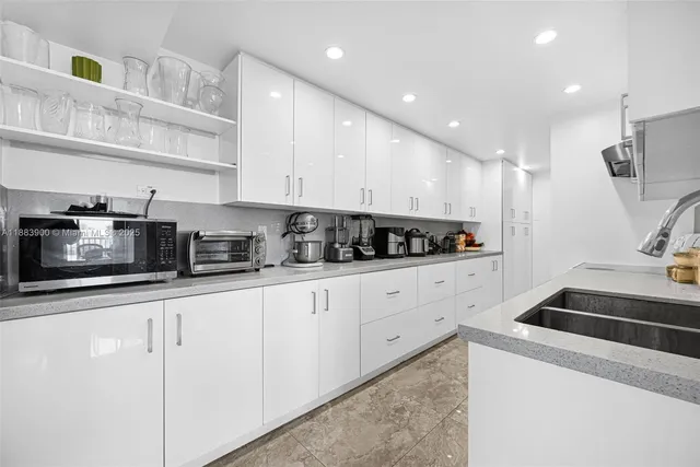 a kitchen with a stove and white cabinets