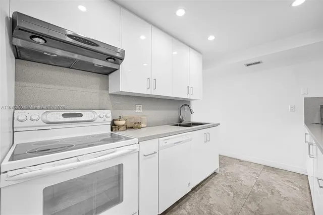 a kitchen with stainless steel appliances granite countertop a sink and cabinets