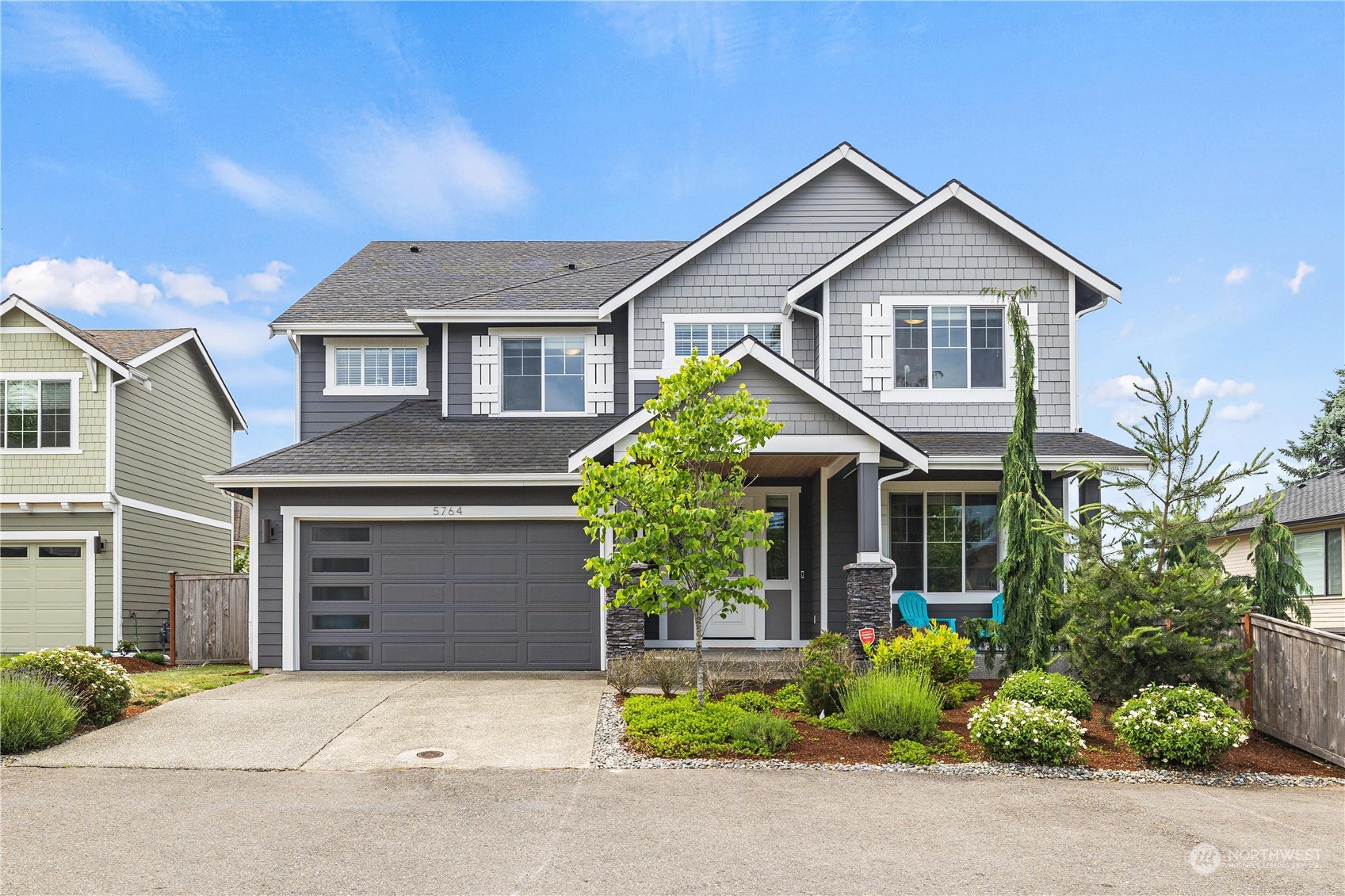 5764 Northeast 7th Court Renton, WA 98059 - Photo 1 of 40 a front view of a house with plants and garden