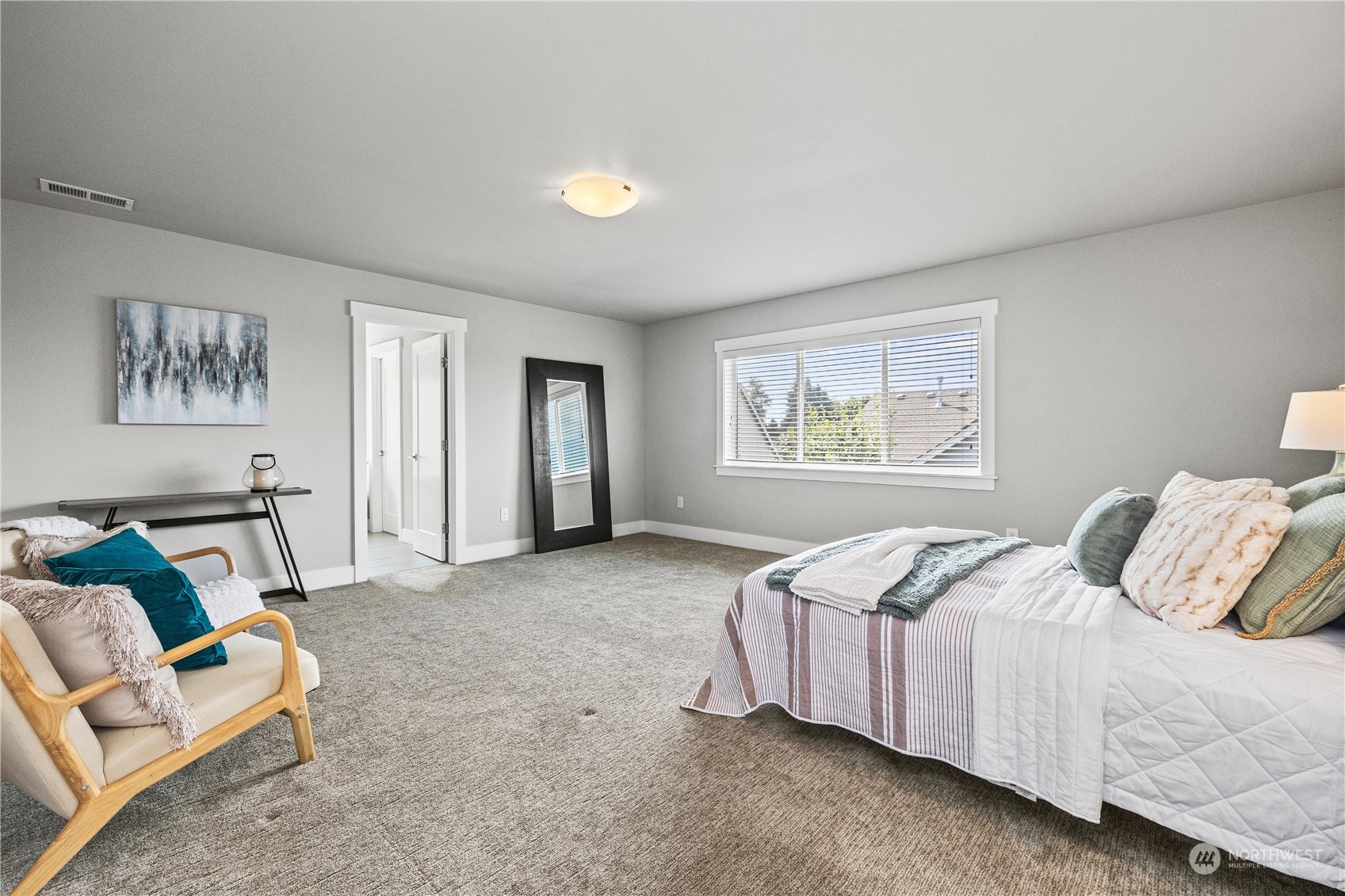 5764 Northeast 7th Court Renton, WA 98059 - Photo 15 of 40 a spacious bedroom with a bed and window