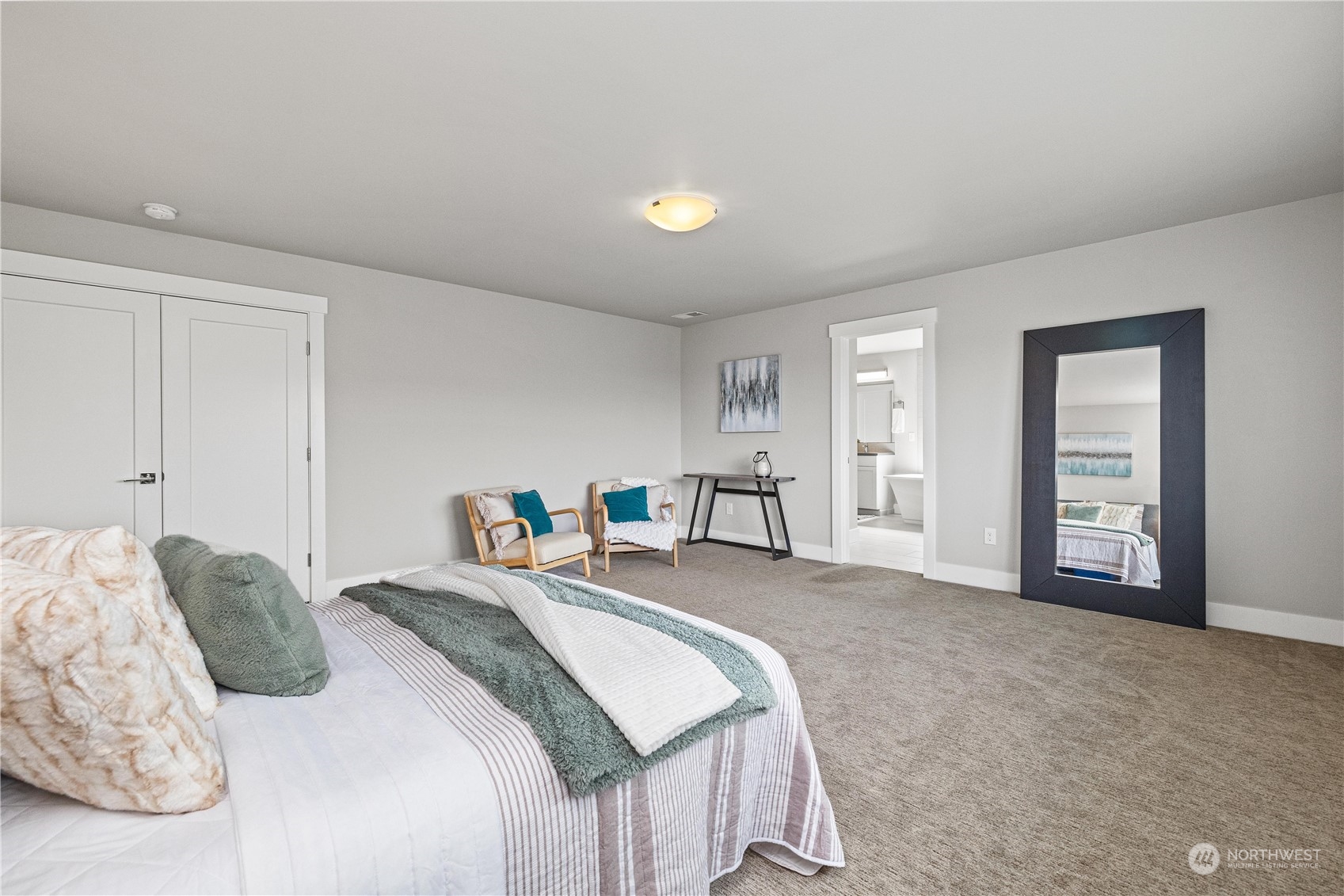 5764 Northeast 7th Court Renton, WA 98059 - Photo 16 of 40 a bedroom with a bed and a lamp
