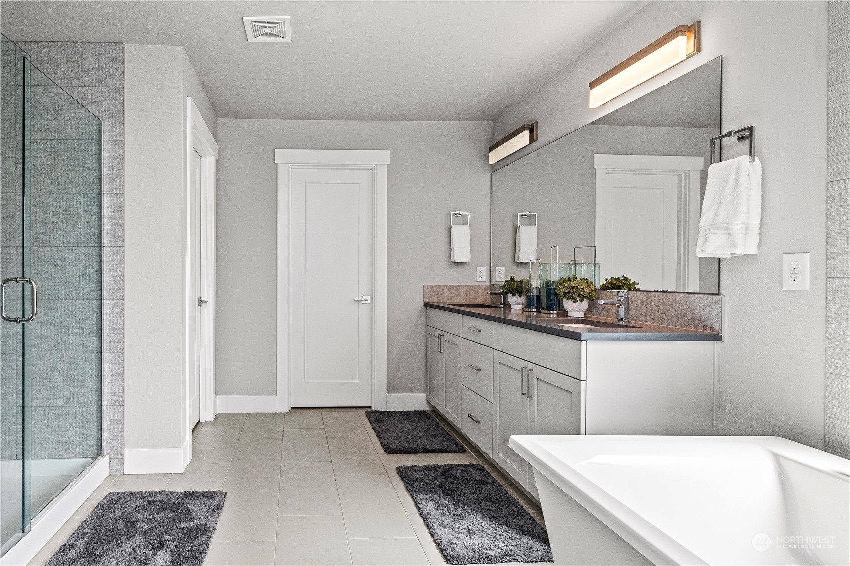 5764 Northeast 7th Court Renton, WA 98059 - Photo 17 of 40 a bathroom with a tub sink and mirror