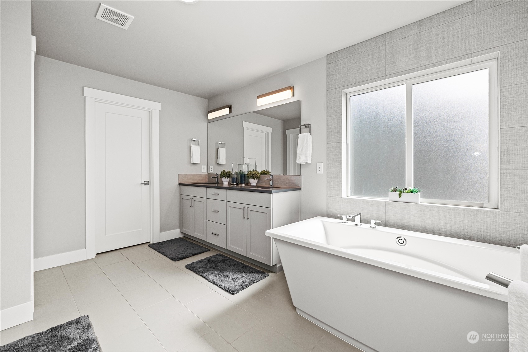 5764 Northeast 7th Court Renton, WA 98059 - Photo 18 of 40 a bathroom with a sink a mirror and a bathtub