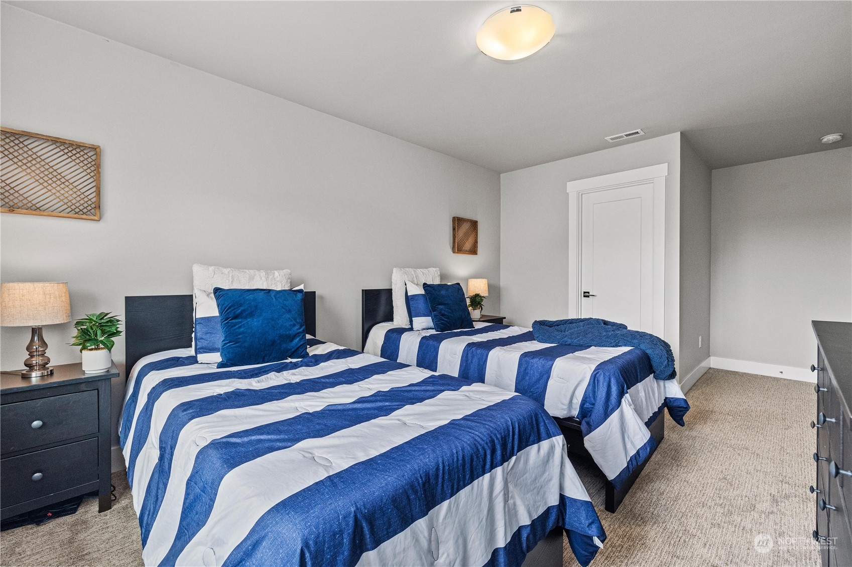 5764 Northeast 7th Court Renton, WA 98059 - Photo 20 of 40 a bedroom with two beds and a lamp