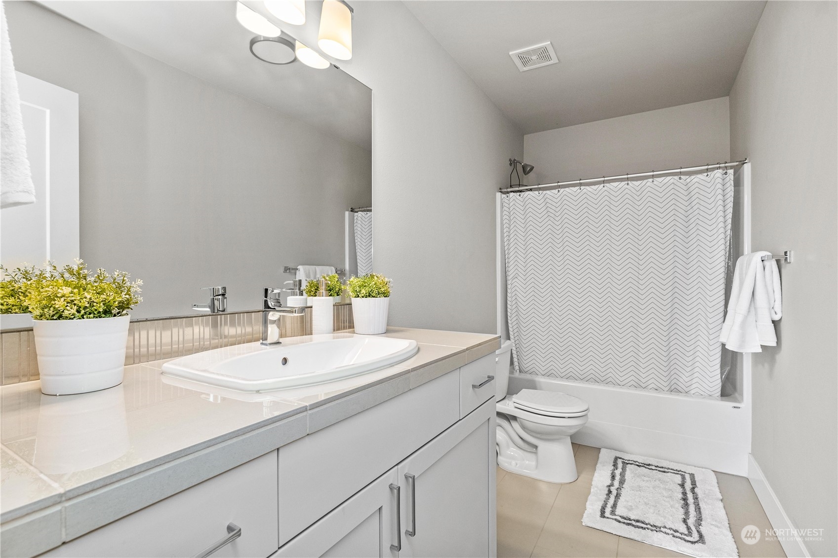 5764 Northeast 7th Court Renton, WA 98059 - Photo 29 of 40 a bathroom with a sink a toilet and shower